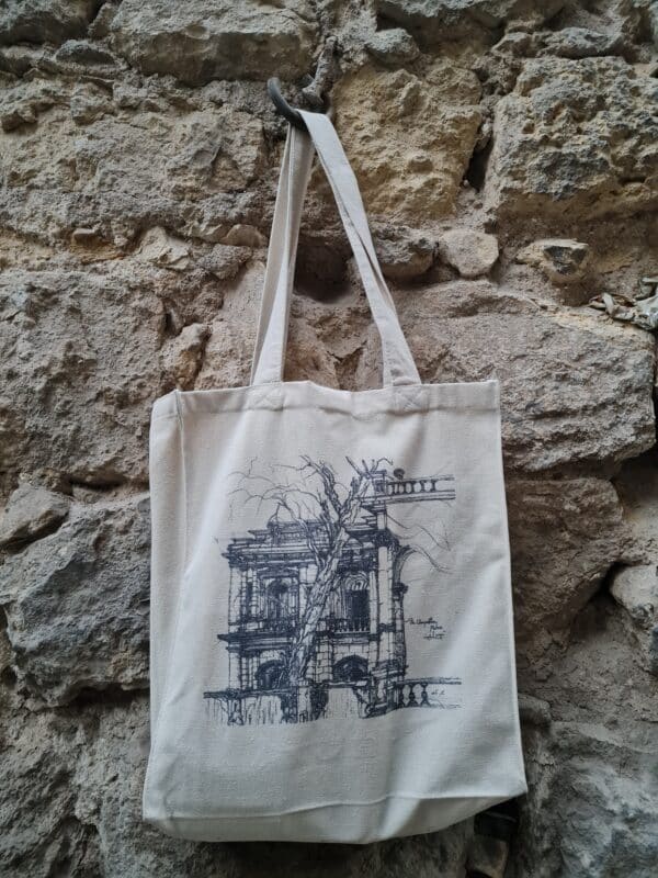 The Champollion's tree tattoo tote bag on stone at the palace.