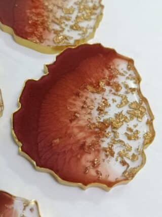 oval bordeaux resin coaster with gold leaves