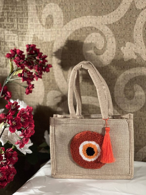 Orange evil eye jute bag