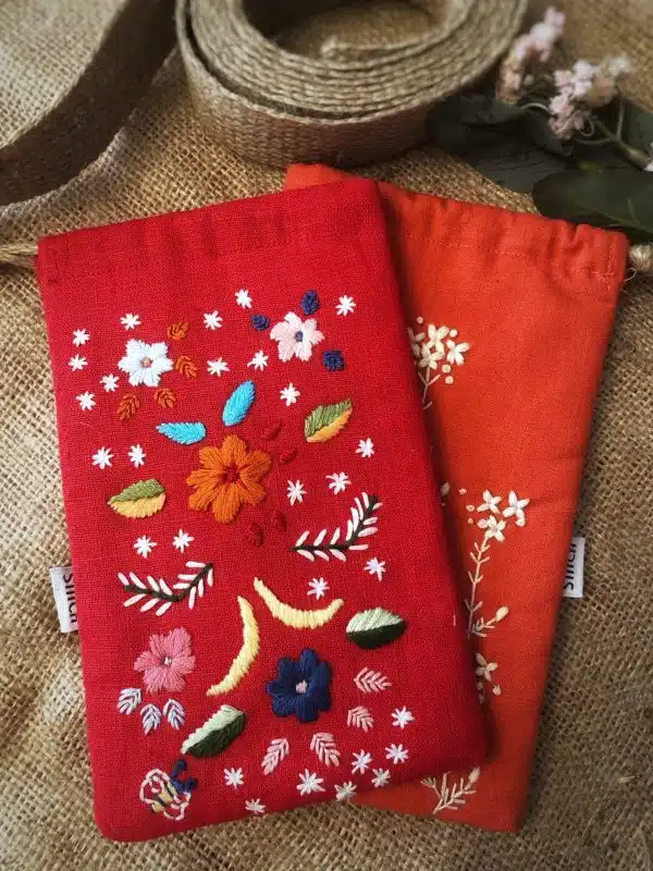 Red padded mobile or sunglasses holder with colorful threads