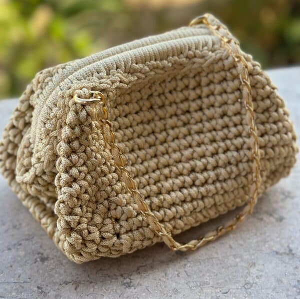 Ivory colored crochet bag with a touch of gold