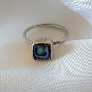 Discover the elegance of simplicity with our Silver Abalone Square Minimal Ring. Crafted with precision, this sleek design features a stunning abalone stone that catches the light with every movement. Perfect for adding a subtle yet sophisticated touch to any loo