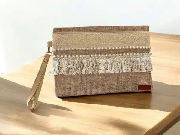Beige clutch with arabic calligraphy and off white fringes