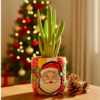 Hand-painted clay planter pot with Santa Claus face design for Christmas decoration, 10cm. | اصيص زرع فخار مرسوم يدوياً بتصميم وجه سانتا كلوز لديكور الكريسماس، مقاس 10 سم