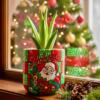 Santa Claus design clay pot with Aloe Vera plant on a window sill with Christmas tree background | أصيص فخار بتصميم سانتا كلوز مزروع بنبات الصبار على نافذة وخلفية شجرة الكريسماس