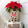 Hand-painted pottery planter pot with a cute cow face design and spots, 10cm size. إصيص زرع فخار مرسوم يدوياً بتصميم وجه بقرة لطيف ومنقط، مقاس 10 سم.