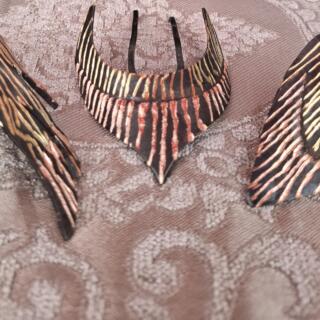 The Tweaks headpieces, copper over brass, oxidized to black, hand-scratched to reveal the metal layers beneath.