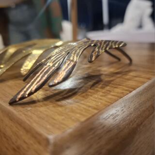 The Flame Tweak headpiece, copper over brass, oxidized to black, hand-scratched to reveal the metal layers beneath.