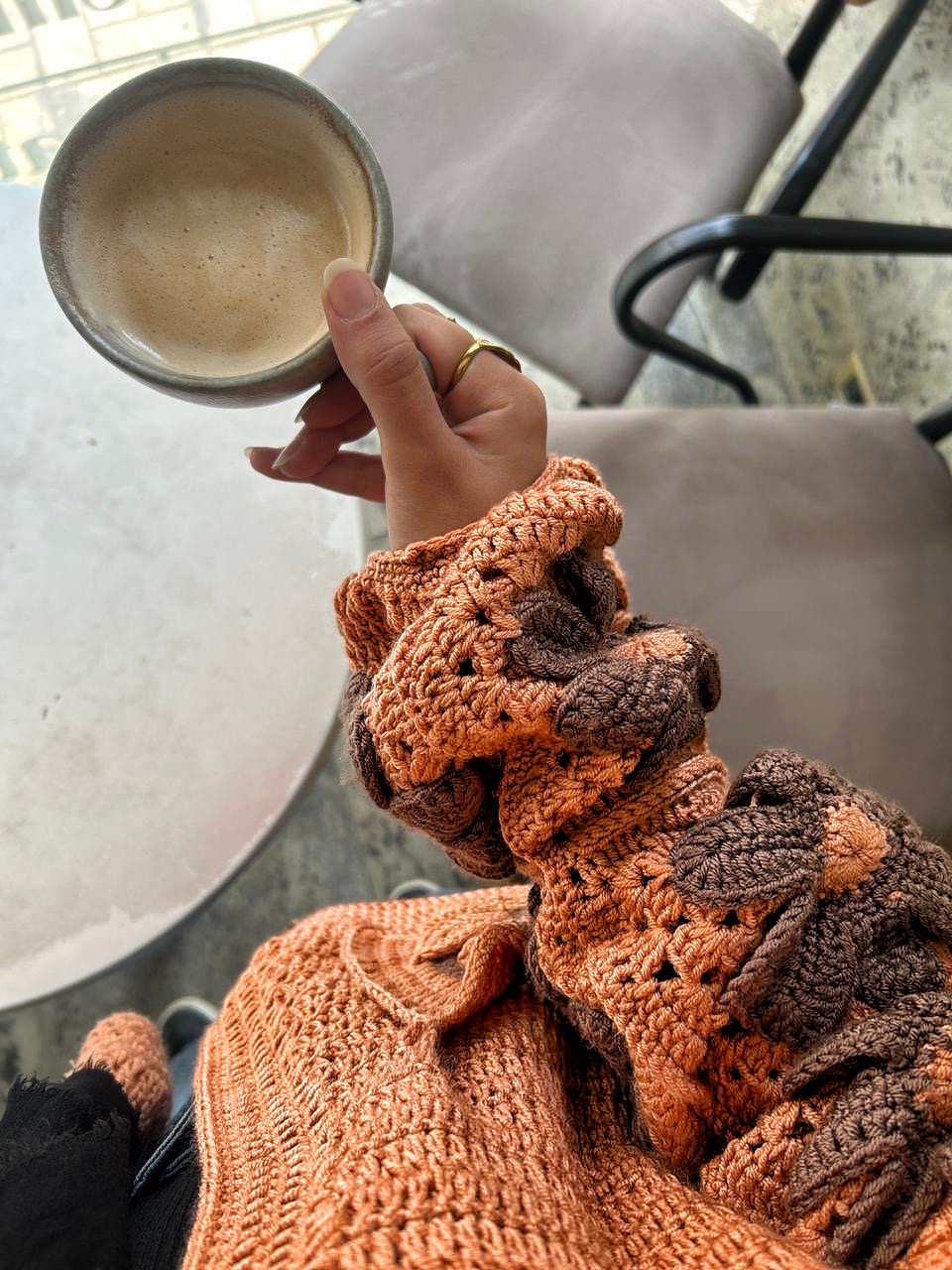 Autumn Bloom Crochet Cardigan 3 Handmade crochet cardigan featuring large 3D floral granny-square patterns in warm orange and brown tones.