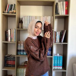 Handmade brown crochet sweater with a textured body and balloon sleeves featuring delicate openwork details.