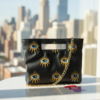 Yellow eyes black Handel clutch