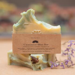 Cinnamon Bliss Soap Bar, a nourishing natural soap with camel milk and cinnamon powder that gently exfoliates, moisturizes, and promotes a healthy, radiant glow, scented with jasmine, lavender, and tea tree oils.