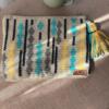 Handmade rectangular clutch bag in off-white tapestry with turquoise, yellow, and gray geometric accents, unique crochet design, perfect for stylish occasions.