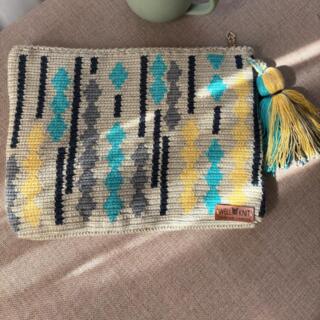Handmade rectangular clutch bag in off-white tapestry with turquoise, yellow, and gray geometric accents, unique crochet design, perfect for stylish occasions.