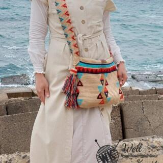 Rectangular beige tapestry crossbody bag with colorful triangle patterns, handmade design.