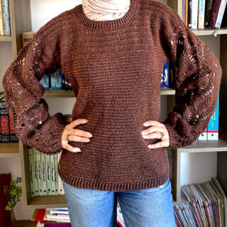 Handmade brown crochet sweater with a textured body and balloon sleeves featuring delicate openwork details.