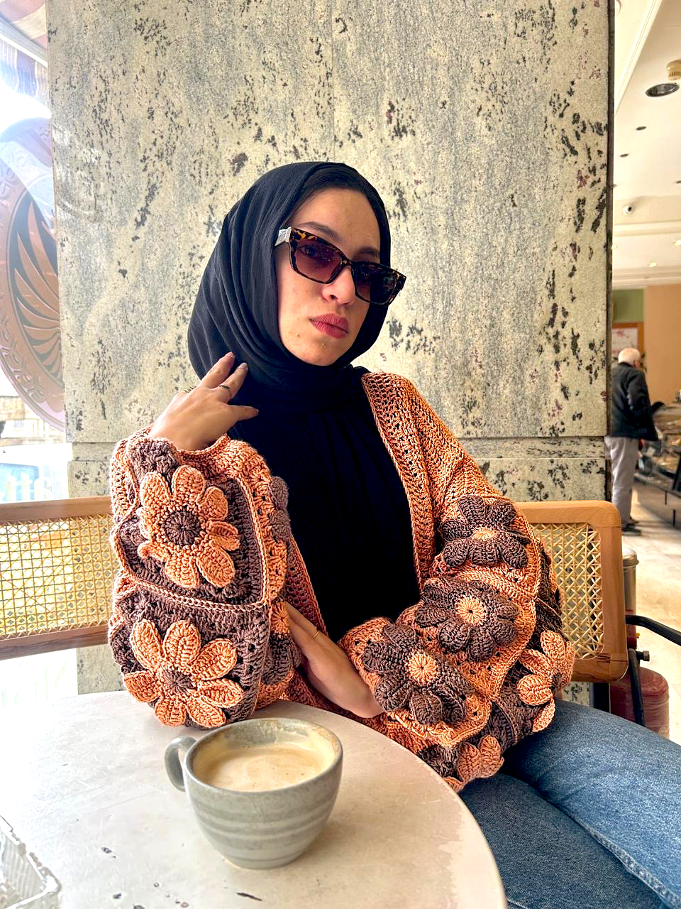 Autumn Bloom Crochet Cardigan 1 Handmade crochet cardigan featuring large 3D floral granny-square patterns in warm orange and brown tones.