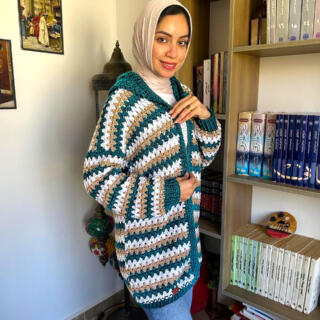 Handmade striped crochet cardigan in teal, white, and beige with a cozy oversized fit