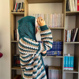 Handmade striped crochet cardigan in teal, white, and beige with a cozy oversized fit.