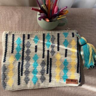 Handmade rectangular clutch bag in off-white tapestry with turquoise, yellow, and gray geometric accents, unique crochet design, perfect for stylish occasions.
