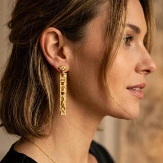Gold plated long hieroglyphic with Lotus earrings .