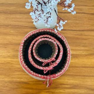Set of handmade crochet storage baskets with decorative stitched edges and tie details, styled as organizers for perfumes, cosmetics, and small essentials.