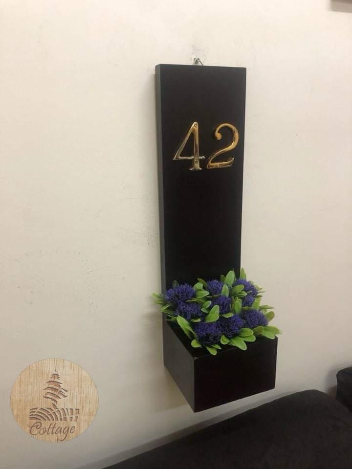 plain door sign with artificial flowers 3 WhatsApp Image 2026 05 22 at 13.51.06