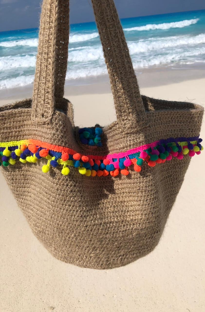 PomPom Jute Tote 5 Handmade jute crochet tote bag with colorful pom-pom trim and sturdy shoulder straps.