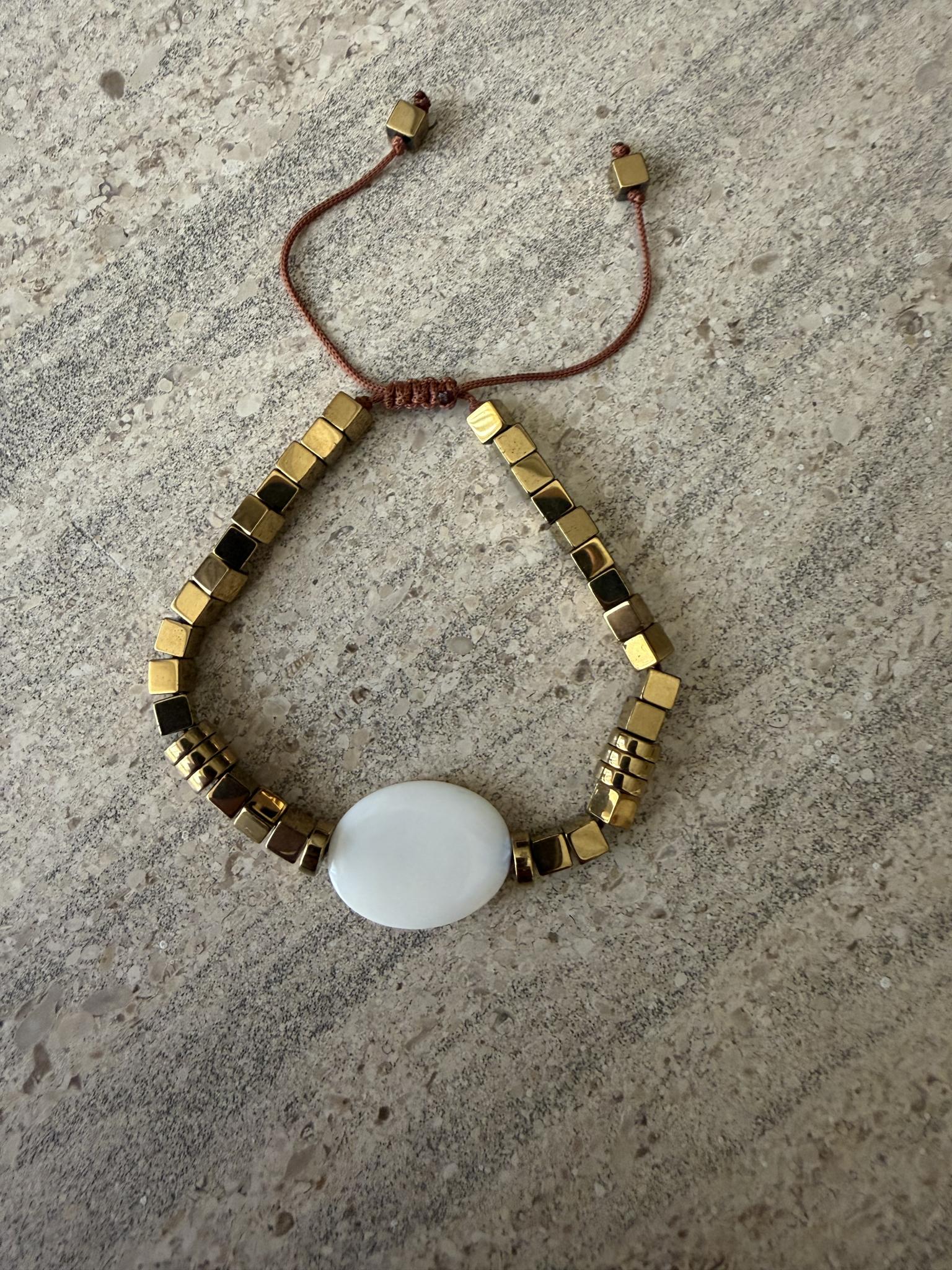 Hematite bracelet with a shell middle stone 2 IMG 2522 scaled